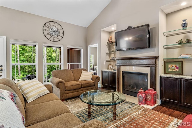1930 Masters Dr, Festus, MO 63028 - living area featuring dark wood finished floors, high vaulted ceiling, and a premium fireplace