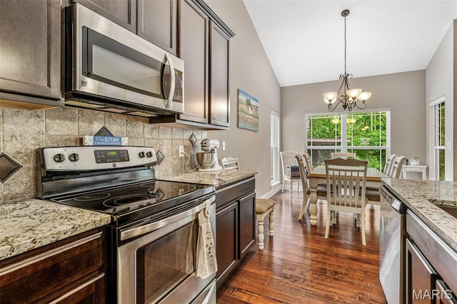1930 Masters Dr, Festus, MO 63028 - kitchen with stainless steel appliances, dark brown cabinets, a chandelier, vaulted ceiling, and tasteful backsplash