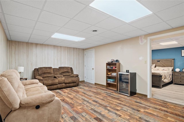 1505 Mulberry St, Jackson, MO 63755 - living area with wine cooler, a drop ceiling, wood finished floors, and wooden walls