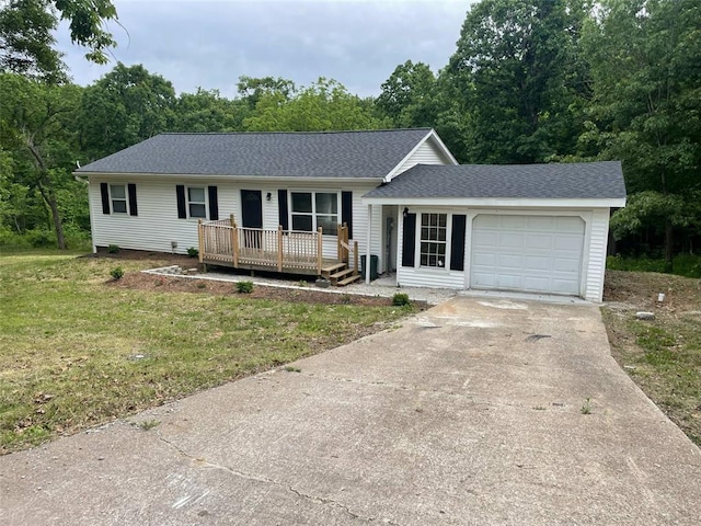 13103 Old 79, New London, MO 63459 - single story home with an attached garage, driveway, a front yard, roof with shingles, and a deck