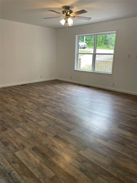 13103 Old 79, New London, MO 63459 - spare room featuring dark wood-style floors, a ceiling fan, and baseboards