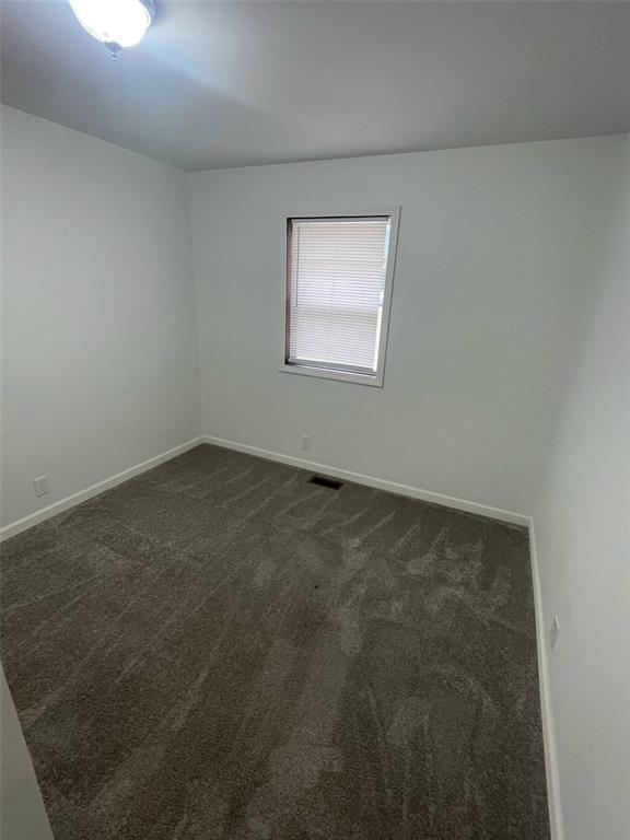 13103 Old 79, New London, MO 63459 - empty room with dark colored carpet and baseboards