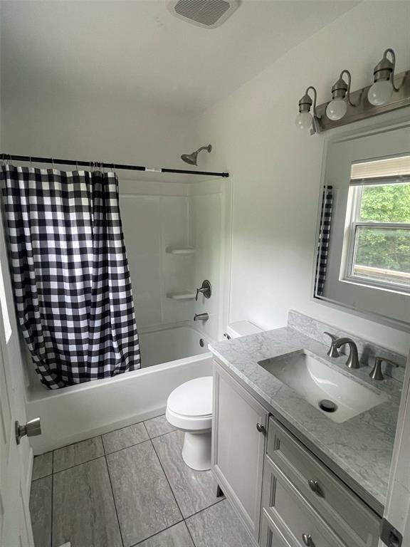 13103 Old 79, New London, MO 63459 - bathroom featuring shower / bathtub combination with curtain, vanity, and toilet