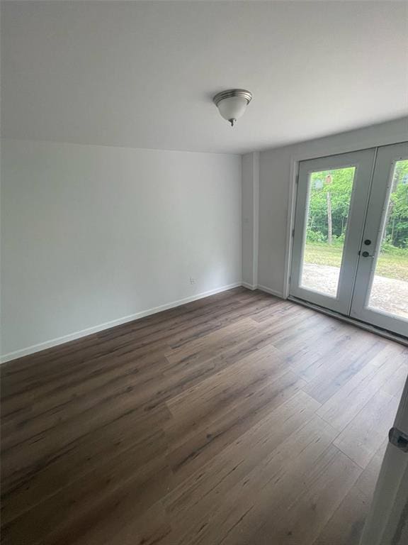 13103 Old 79, New London, MO 63459 - empty room with french doors, dark wood finished floors, and baseboards