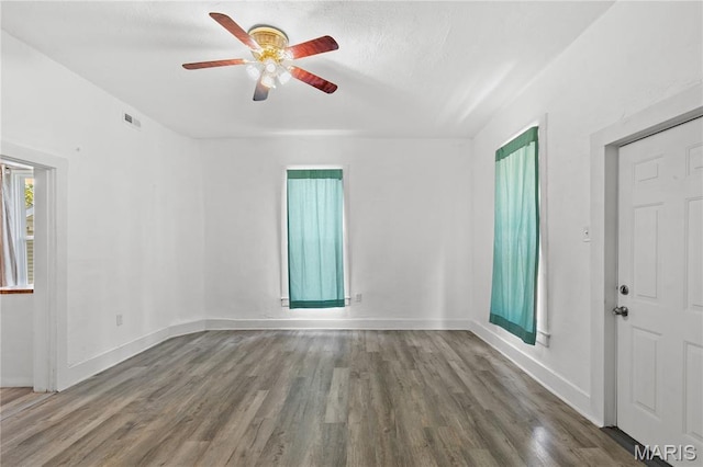 1217 E 5th St, Alton, IL 62002 - empty room featuring ceiling fan, wood finished floors, and baseboards