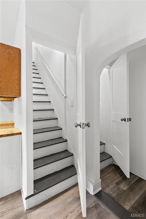 1217 E 5th St, Alton, IL 62002 - staircase featuring wood finished floors and arched walkways