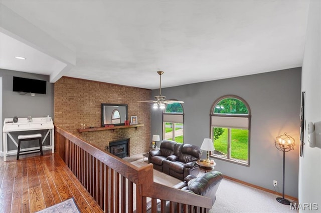 3536 Possum Ridge Dr, Imperial, MO 63052 - living area featuring baseboards, a brick fireplace, a ceiling fan, and wood-type flooring