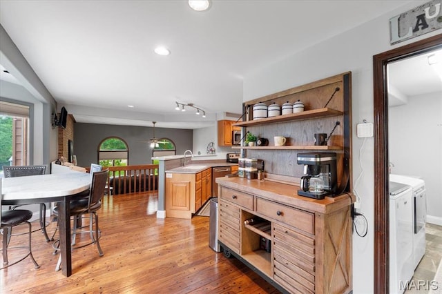 3536 Possum Ridge Dr, Imperial, MO 63052 - kitchen featuring separate washer and dryer, open shelves, a sink, light countertops, and a peninsula