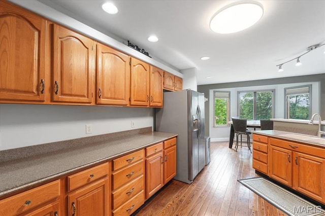 3536 Possum Ridge Dr, Imperial, MO 63052 - kitchen with a sink, stainless steel fridge with ice dispenser, brown cabinets, wood-type flooring, and track lighting