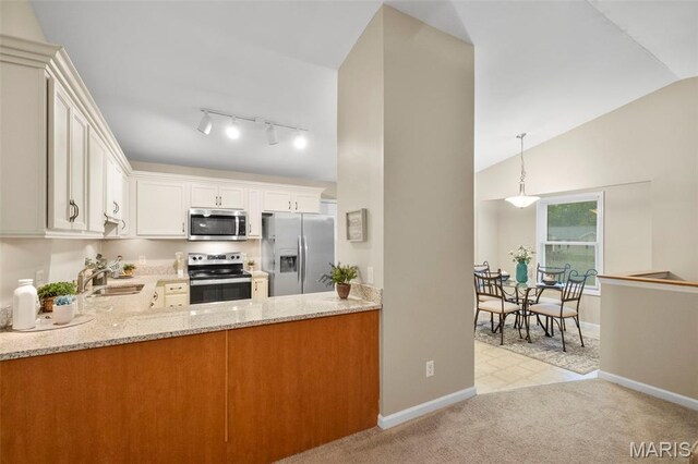 30 Citori Ct, Troy, MO 63379 - kitchen with appliances with stainless steel finishes, light stone counters, baseboards, a peninsula, and high vaulted ceiling