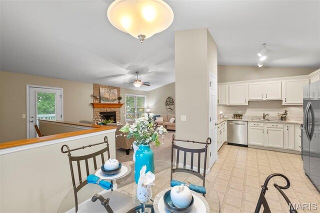 30 Citori Ct, Troy, MO 63379 - dining area with ceiling fan, a large fireplace, baseboards, and lofted ceiling