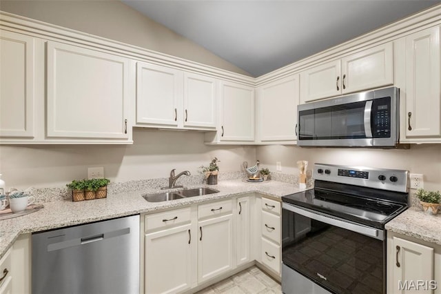 30 Citori Ct, Troy, MO 63379 - kitchen featuring appliances with stainless steel finishes, a sink, vaulted ceiling, light stone countertops, and white cabinetry