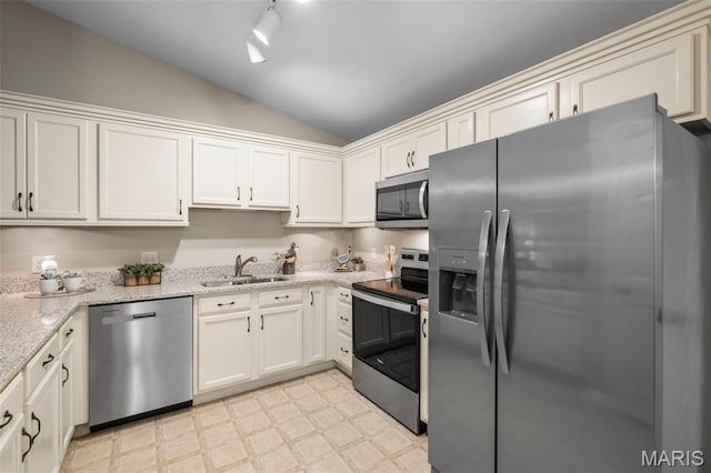 30 Citori Ct, Troy, MO 63379 - kitchen with appliances with stainless steel finishes, vaulted ceiling, a sink, light flooring, and light stone countertops