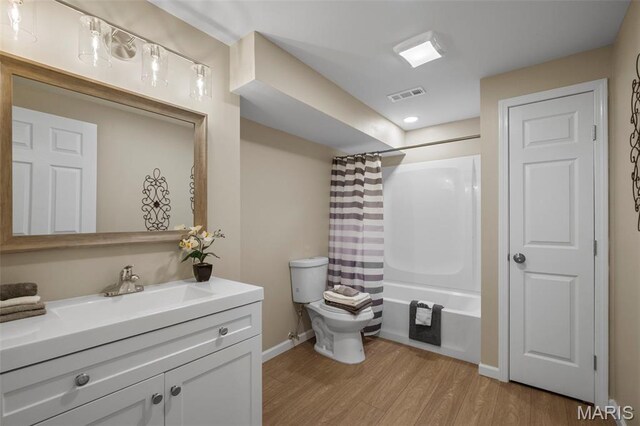 30 Citori Ct, Troy, MO 63379 - bathroom with wood finished floors, toilet, vanity, shower / bath combo with shower curtain, and baseboards
