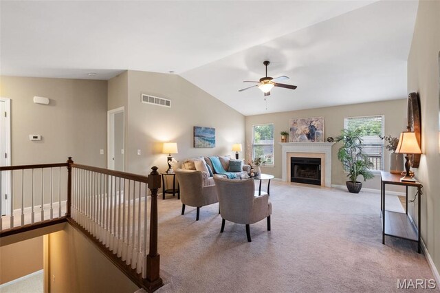 171 Majestic Lakes Blvd, Moscow Mills, MO 63362 - living room with light colored carpet, plenty of natural light, ceiling fan, vaulted ceiling, and a fireplace with flush hearth