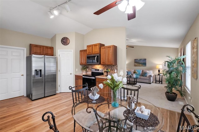 171 Majestic Lakes Blvd, Moscow Mills, MO 63362 - kitchen featuring stainless steel appliances, a ceiling fan, vaulted ceiling, rail lighting, and open floor plan