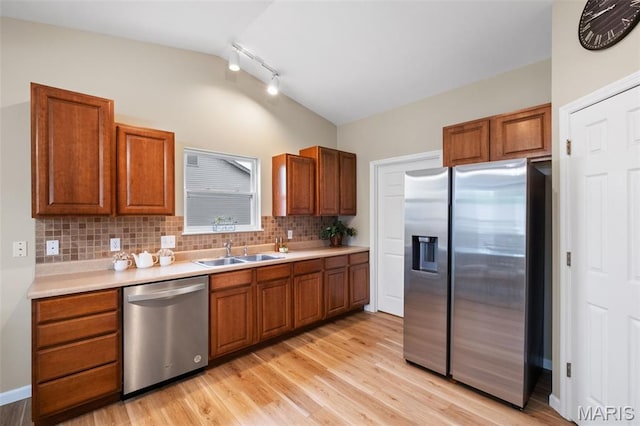 171 Majestic Lakes Blvd, Moscow Mills, MO 63362 - kitchen with stainless steel appliances, a sink, rail lighting, brown cabinets, and lofted ceiling