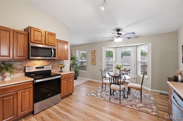171 Majestic Lakes Blvd, Moscow Mills, MO 63362 - kitchen with appliances with stainless steel finishes, tasteful backsplash, light countertops, and brown cabinetry