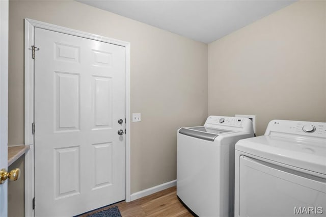 171 Majestic Lakes Blvd, Moscow Mills, MO 63362 - laundry room featuring washer and dryer, light wood-style flooring, and baseboards