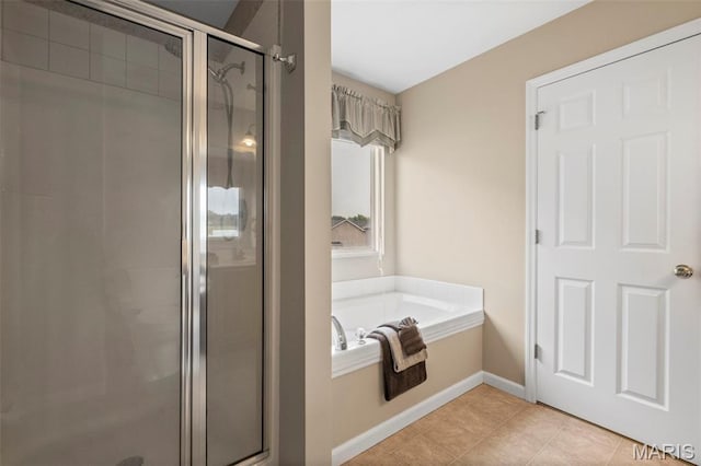 171 Majestic Lakes Blvd, Moscow Mills, MO 63362 - full bath featuring a stall shower, a garden tub, tile patterned floors, and baseboards
