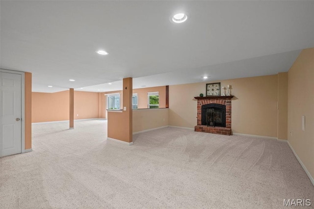 171 Majestic Lakes Blvd, Moscow Mills, MO 63362 - unfurnished living room with light colored carpet, baseboards, a fireplace, and recessed lighting