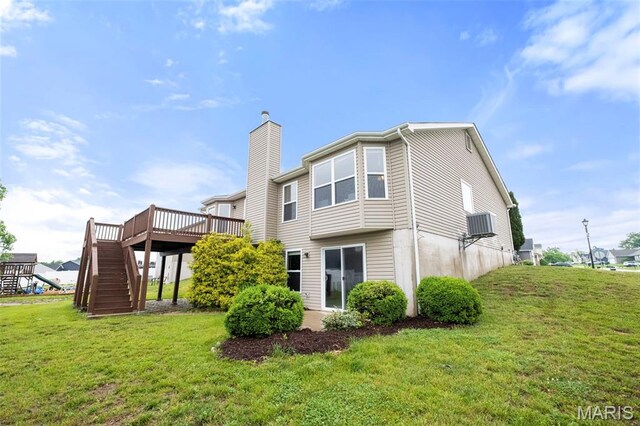 171 Majestic Lakes Blvd, Moscow Mills, MO 63362 - rear view of house with stairway, a chimney, a deck, and a yard