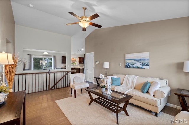 2231 Central Park Dr, Troy, MO 63379 - living room featuring light wood-style flooring, ceiling fan, high vaulted ceiling, and baseboards