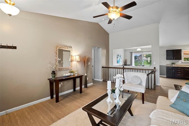 2231 Central Park Dr, Troy, MO 63379 - living area with a ceiling fan, light wood-type flooring, high vaulted ceiling, and baseboards