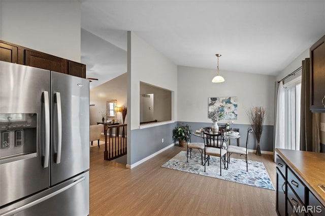 2231 Central Park Dr, Troy, MO 63379 - dining space with lofted ceiling, light wood-style floors, and baseboards