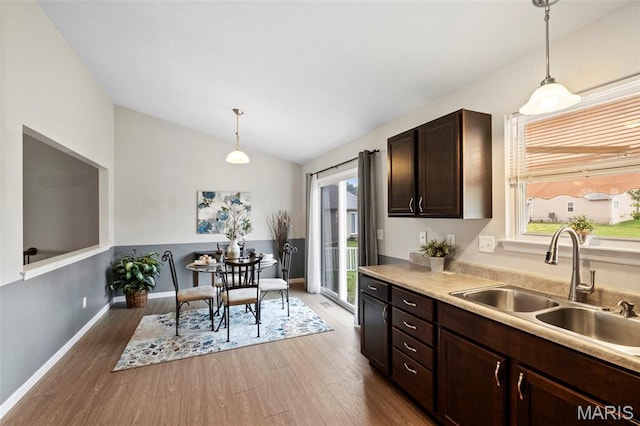 2231 Central Park Dr, Troy, MO 63379 - kitchen featuring a sink, vaulted ceiling, healthy amount of natural light, dark wood-type flooring, and dark brown cabinets