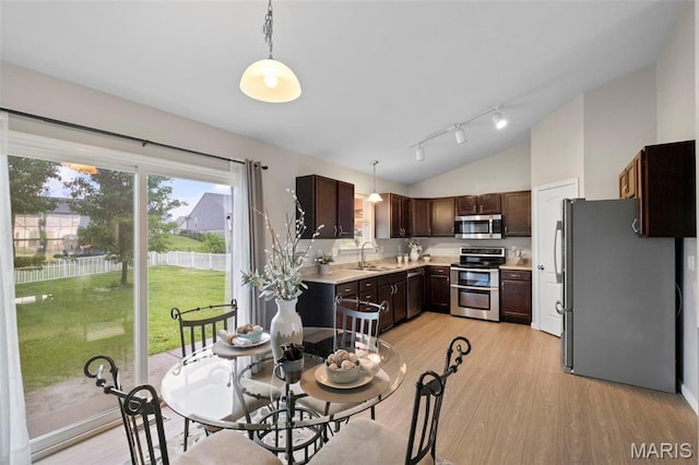 2231 Central Park Dr, Troy, MO 63379 - dining room featuring lofted ceiling, light wood-style floors, and rail lighting