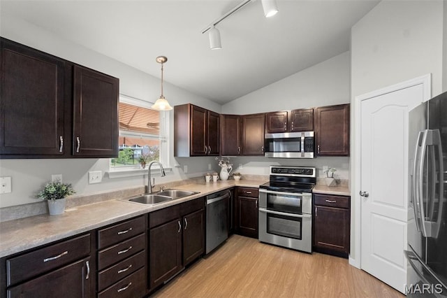 2231 Central Park Dr, Troy, MO 63379 - kitchen with stainless steel appliances, a sink, light wood-style flooring, lofted ceiling, and dark brown cabinetry
