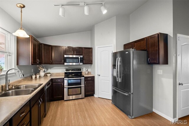 2231 Central Park Dr, Troy, MO 63379 - kitchen with appliances with stainless steel finishes, a sink, light wood-type flooring, lofted ceiling, and dark brown cabinetry