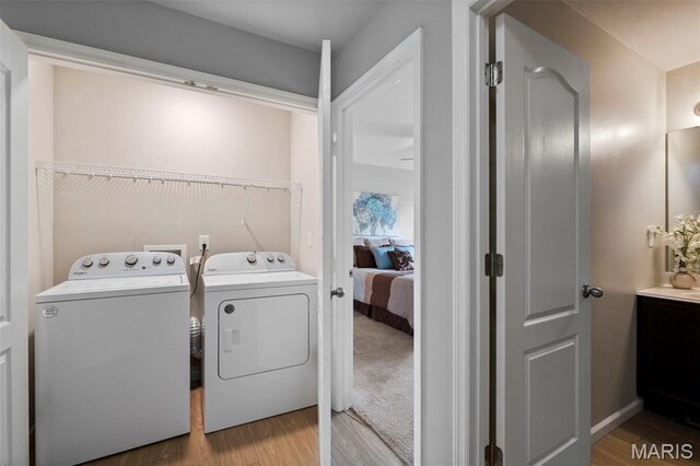 2231 Central Park Dr, Troy, MO 63379 - laundry room featuring washing machine and clothes dryer and wood finished floors