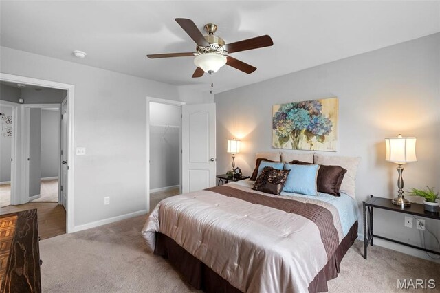 2231 Central Park Dr, Troy, MO 63379 - carpeted bedroom featuring baseboards, ceiling fan, a closet, and a walk in closet