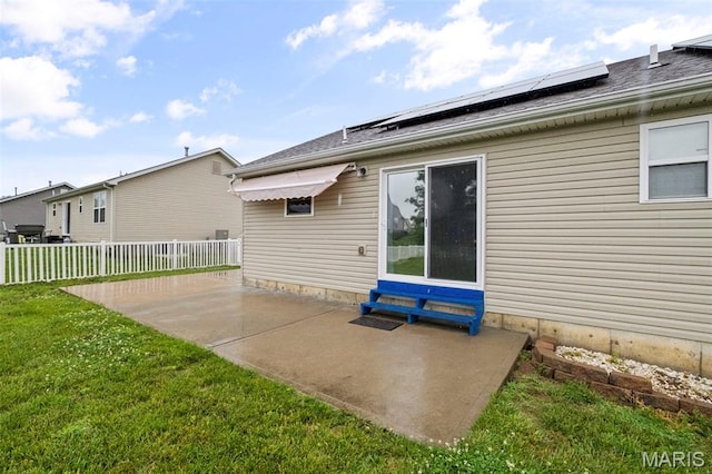 2231 Central Park Dr, Troy, MO 63379 - back of property with a patio area, solar panels, and a shingled roof