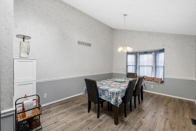 9513 Sequoia Ct, Affton, MO 63123 - dining area with lofted ceiling, wood finished floors, a chandelier, and baseboards