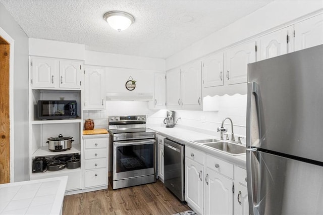 9513 Sequoia Ct, Affton, MO 63123 - kitchen featuring stainless steel appliances, a sink, white cabinetry, a textured ceiling, and dark wood-style floors