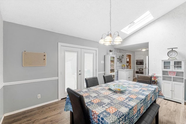 9513 Sequoia Ct, Affton, MO 63123 - dining room featuring wood finished floors, a chandelier, a skylight, french doors, and lofted ceiling
