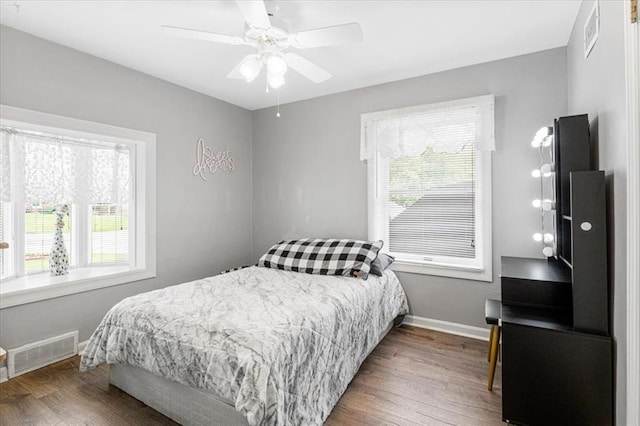 9513 Sequoia Ct, Affton, MO 63123 - bedroom featuring multiple windows, wood finished floors, baseboards, and a ceiling fan