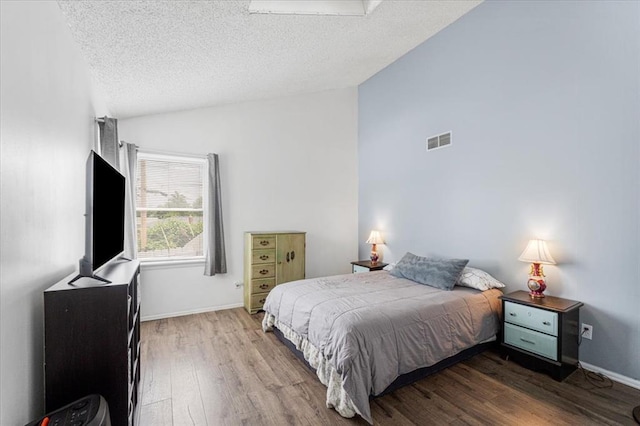 9513 Sequoia Ct, Affton, MO 63123 - bedroom with lofted ceiling, wood finished floors, a textured ceiling, and baseboards