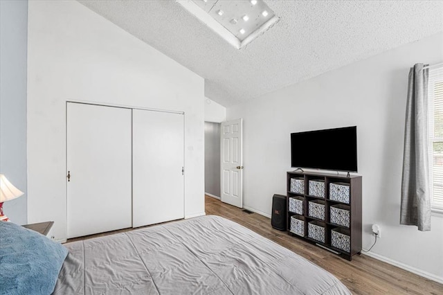 9513 Sequoia Ct, Affton, MO 63123 - bedroom featuring wood finished floors, a textured ceiling, a closet, baseboards, and high vaulted ceiling