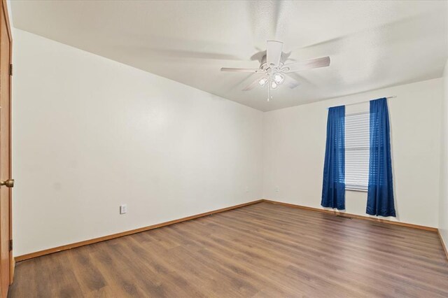 2032 New Sun Dr, Florissant, MO 63031 - empty room featuring wood finished floors, baseboards, and ceiling fan