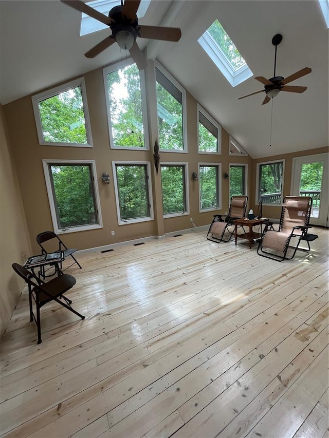 16453 Scenic Ridge Rd, Marthasville, MO 63357 - living area with a skylight, high vaulted ceiling, ceiling fan, and hardwood / wood-style flooring