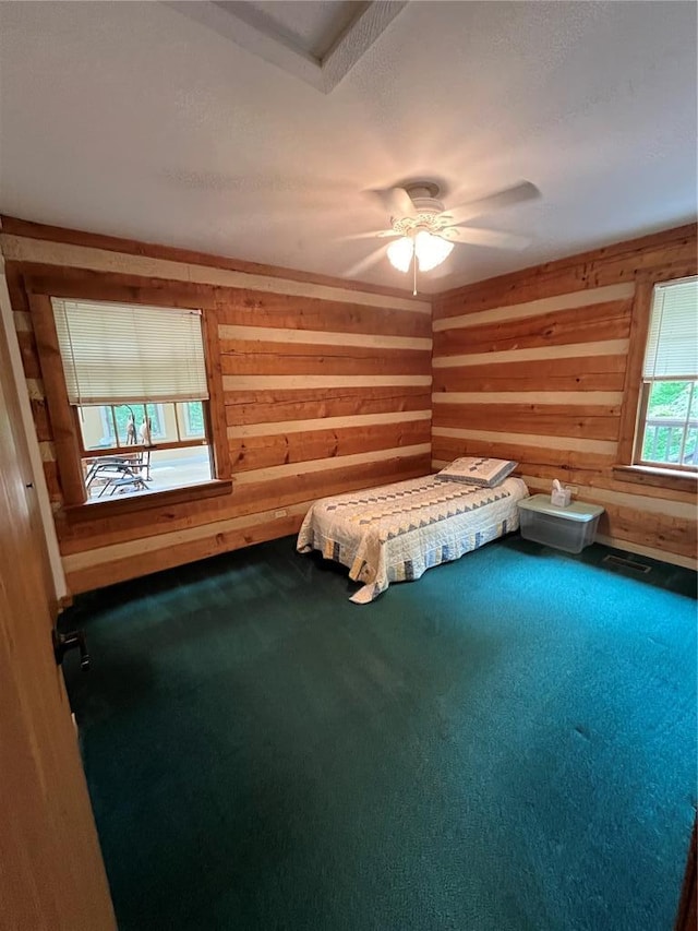 16453 Scenic Ridge Rd, Marthasville, MO 63357 - unfurnished bedroom with wooden walls, carpet floors, and a ceiling fan