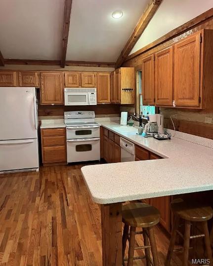 16453 Scenic Ridge Rd, Marthasville, MO 63357 - kitchen with white appliances, light countertops, a peninsula, and brown cabinetry