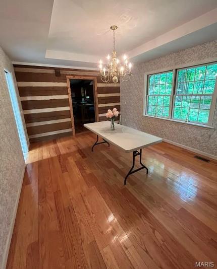 16453 Scenic Ridge Rd, Marthasville, MO 63357 - unfurnished dining area with wood finished floors and a chandelier