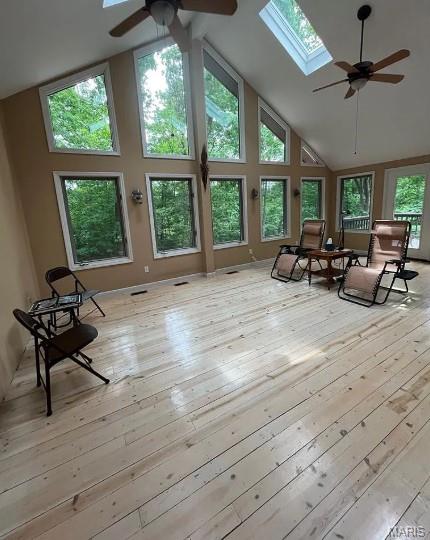 16453 Scenic Ridge Rd, Marthasville, MO 63357 - sunroom / solarium with a skylight, high vaulted ceiling, a wooden deck, and hardwood / wood-style floors