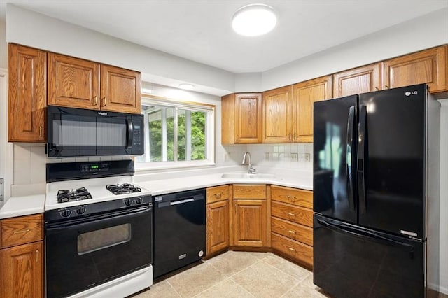 13105 Dartagnan Ct, Creve Coeur, MO 63141 - kitchen featuring black appliances, a sink, brown cabinets, and decorative backsplash