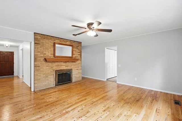 13105 Dartagnan Ct, Creve Coeur, MO 63141 - unfurnished living room featuring light wood-type flooring, ceiling fan, a fireplace, and baseboards